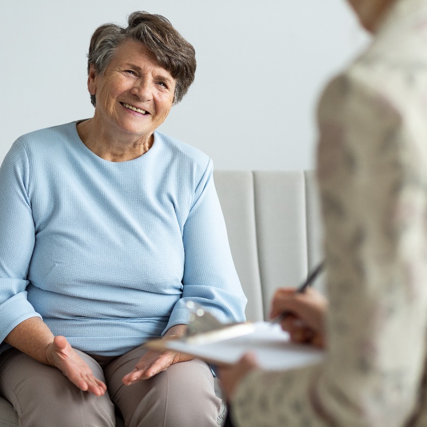 Elderly woman talking with financial advisor about loan during appointment